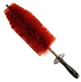 Red brush with black handle on a white background
